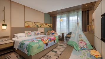 A hotel room with a large bed, a desk, a chair, a TV, and a window with curtains.