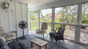 A covered porch with a sofa, chairs, a fan, and a table. - Pet Friendly Sleeps 9 Golf Cart Hot Tub - Weekly Discounts (St.Geroge Island)