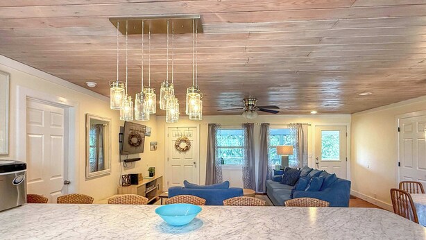 A kitchen with a marble island, hanging light fixtures, and a ceiling fan. - Pet Friendly Sleeps 9 Golf Cart Hot Tub - Weekly Discounts (St.Geroge Island)