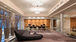 A modern lobby with a reception desk, seating area, and large windows. - Valbusenda Hotel Bodega and Spa (Toro)