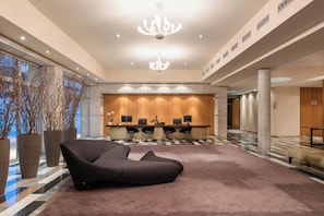 A modern lobby with a reception desk, seating area, and large windows. - Valbusenda Hotel Bodega and Spa (Toro)
