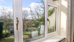 A window with a view of a garden and trees. - The Old Croft (Buxton)