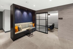 Relax in the stylish seating area with a sofa and comfortable cushions.