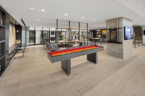 Welcome to our hotel lobby, featuring a spacious central area with a reception desk, seating area, and staircase.