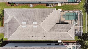 Una terraza con un diseño geométrico, un espacio al aire libre cubierto y un recinto de vidrio.