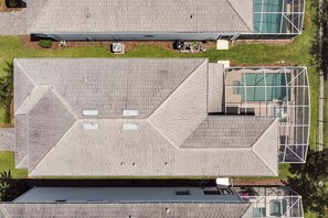 Eine Dachterrasse mit geometrischem Muster, einem überdachten Außenbereich und einer Glaskonstruktion.