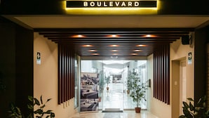 The entrance to Central Boulevard hotel with a modern design, including a sign above the entrance and a staircase leading inside. - Xima Central Tacna (Tacna)