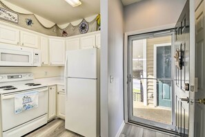 Enjoy cooking in this well-equipped kitchen with a microwave, oven, and refrigerator.
