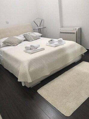 Comfortable retreat with a neatly made bed and plush towels.