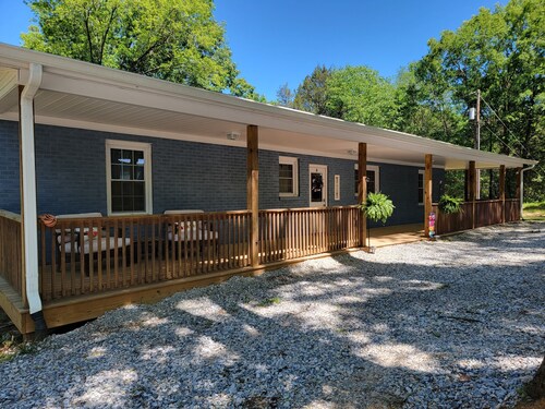 Charming brick home set in the woods on 45 acres with pond and trails.