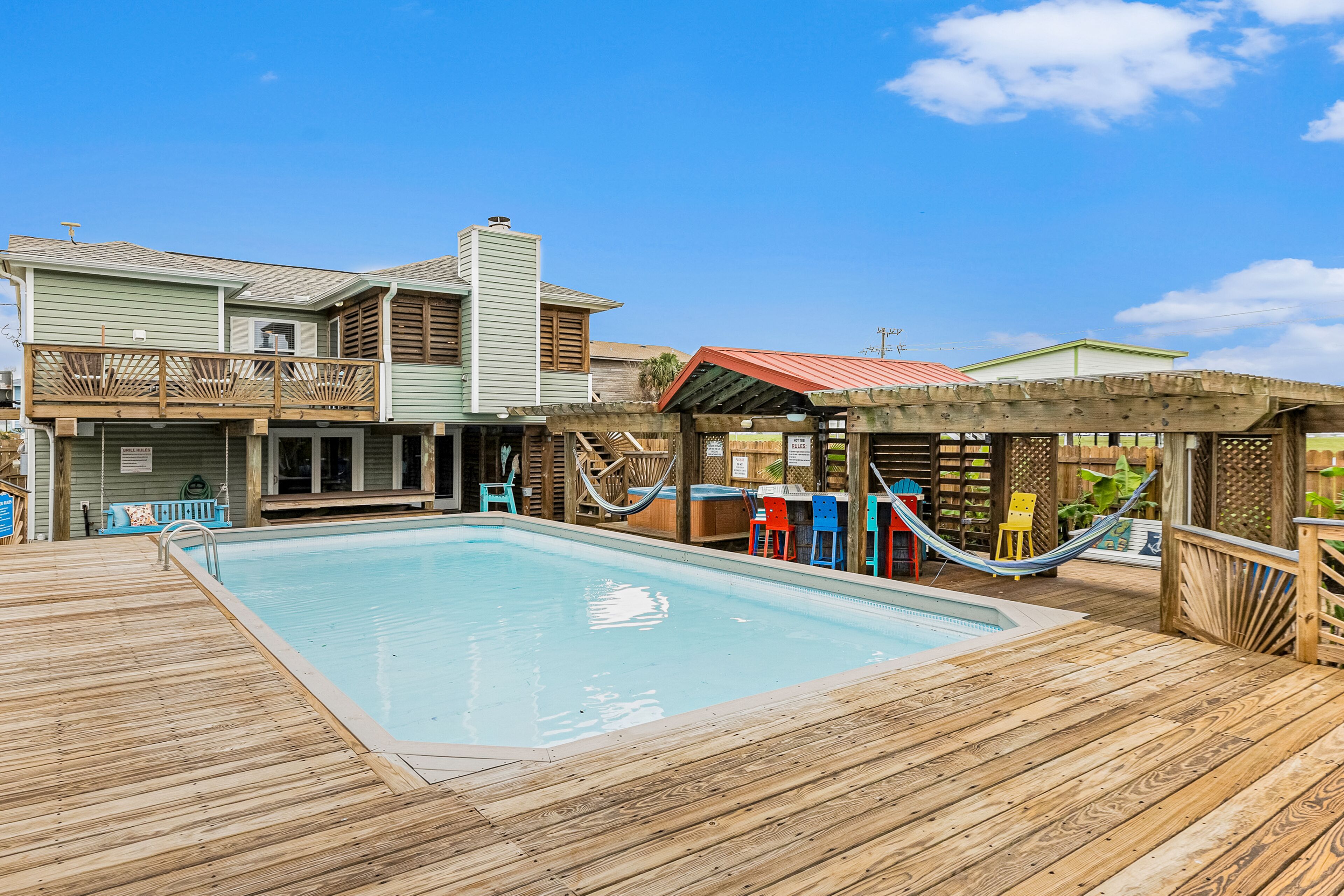 Roomy, two-story retreat with a pool, hot tub, & bars - close to the beach