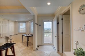 Stroll through this inviting hallway to a balcony with city views.