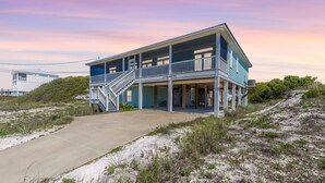 A two-story beachfront house with a balcony, a staircase, and a covered porch. - Early DISCOUNT heated pool 6Bed4Bath BeachVilla Steps2Sand (Gulf Shores)