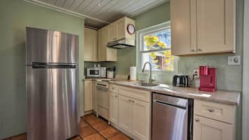 Enjoy cooking in this well-equipped kitchen with a refrigerator, microwave, stove, and dishwasher.