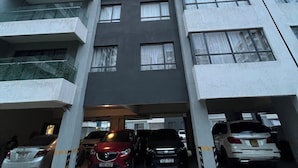 A multi-story residential building with a parking garage. - Indesign Studio  (Syokimau)