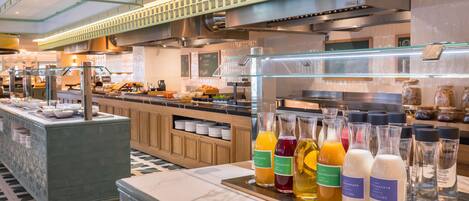 A hotel buffet with a variety of food items and beverages.