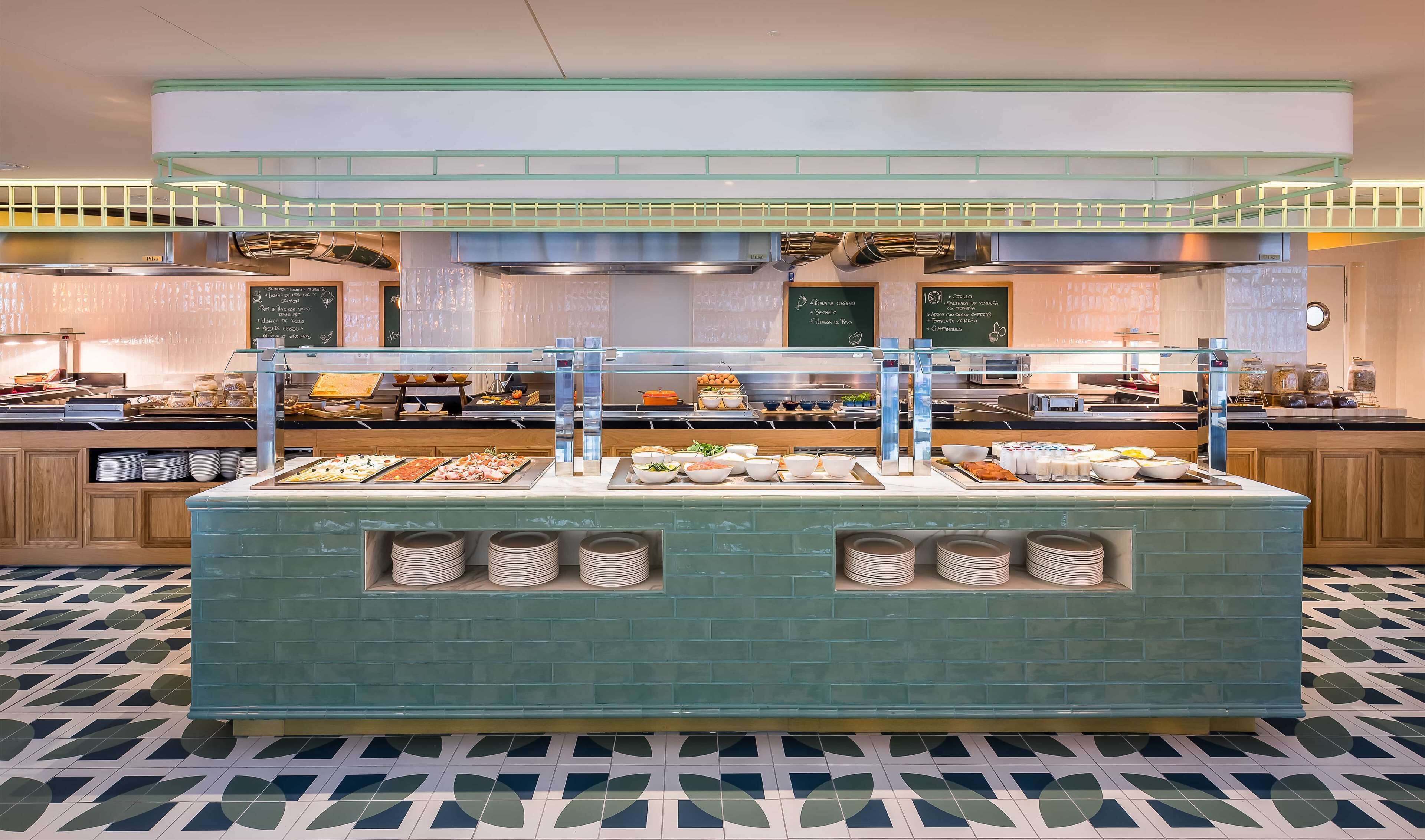 A buffet area with various food options and a chalkboard menu.