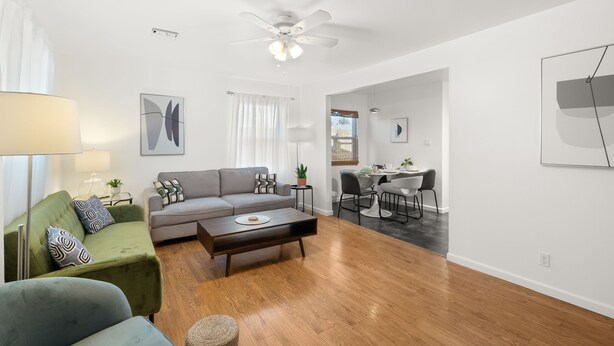 A modern living room with a sofa, coffee table, and dining area with chairs. - Central Phx Kid/Pet friendly home next to Banner Hospital & Historic Coronado (Phoenix)