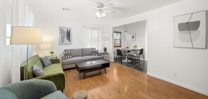 A modern living room with a sofa, coffee table, and dining area with chairs. - Central Phx Kid/Pet friendly home next to Banner Hospital & Historic Coronado (Phoenix)
