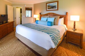 A neatly made bed with a patterned bedspread, a wooden headboard, and two bedside lamps. - 2Br/2Ba in beautiful Kauai! Bali Hai Villas, pool, hot tub, AC! (Princeville)