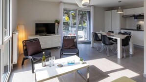 A modern apartment with a living area, dining space, and kitchen. - Les Cyprès by Interhome (Saint Malo)