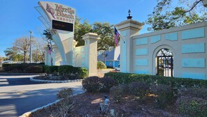 The entrance to Myrtle Beach Resort with a large sign, an American flag, and a gated entrance. - ^^Amazing Ocean View, Super Clean w/ Towels/Linen,1G WIFI @ Myrtle Beach Resort  (Myrtle Beach)
