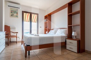 A bedroom with a bed, a chair, a dresser, a nightstand, and a window with curtains. - Villa Mila with beautiful sea view (Pineto)