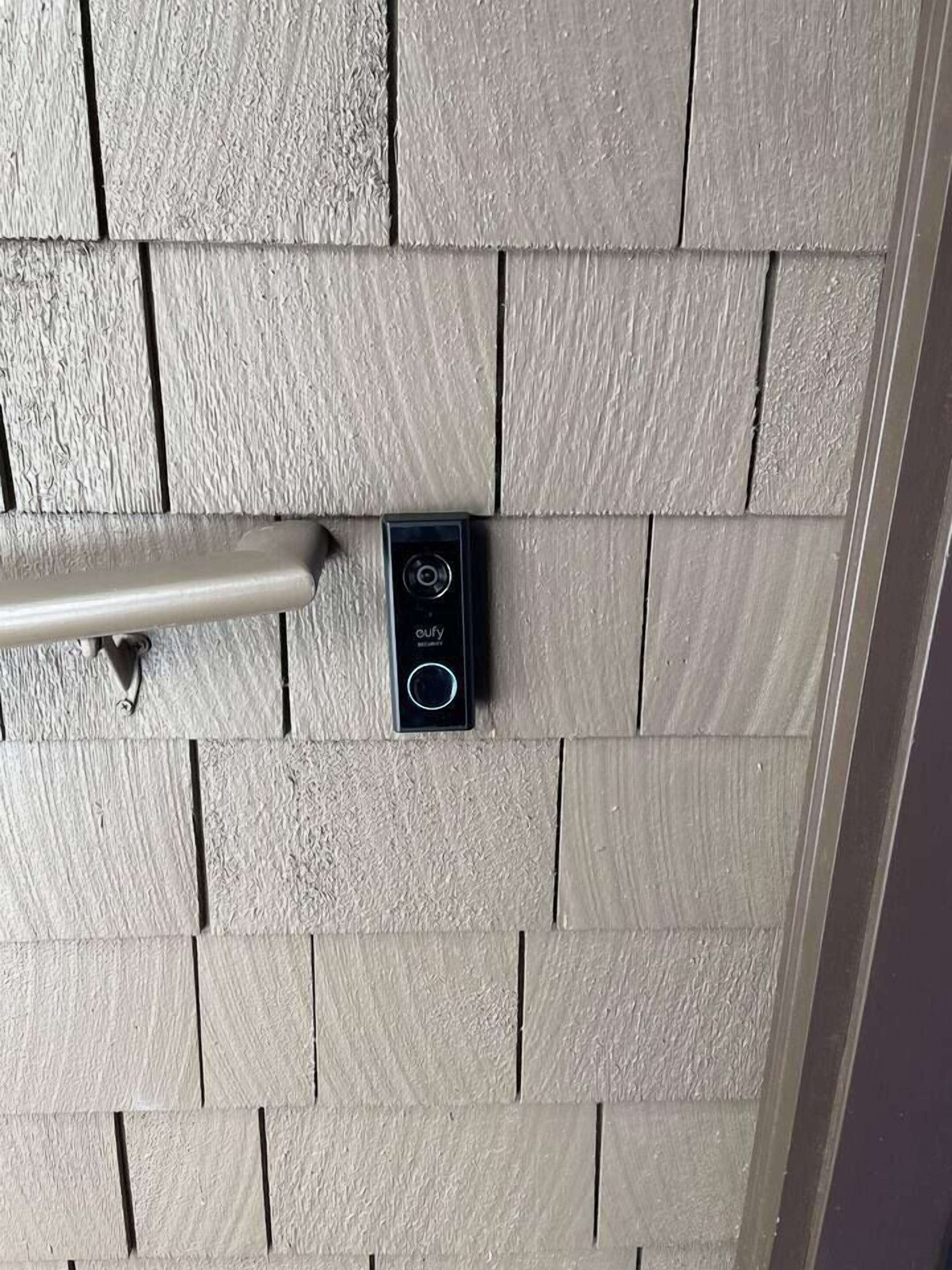 A door with a textured wooden panel design and a modern electronic lock system.