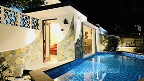 A modern house with a swimming pool, stone walls, and a door leading to a living area. - Mermaid  Island Beach Resort (Vanur)