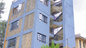 A multi-story building with a blue facade, multiple balconies, and visible windows. - Countryside Apartments -With Unlimited WIFI&Netflix (Nairobi)
