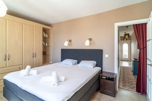 Comfortable accommodations feature a large bed, wardrobe, and bedside table.