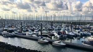 A marina with numerous boats docked at the piers.