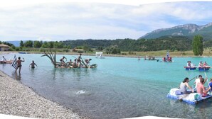 A lake with boats, people, and a mountainous backdrop. - Gîte des Anges, 2 pers. swimming pool, direct access to the river La Méouge (Barret-sur-Méouge)