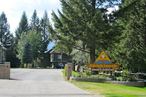 Enter the serene Akiskink estate, surrounded by lush evergreen trees and a road.