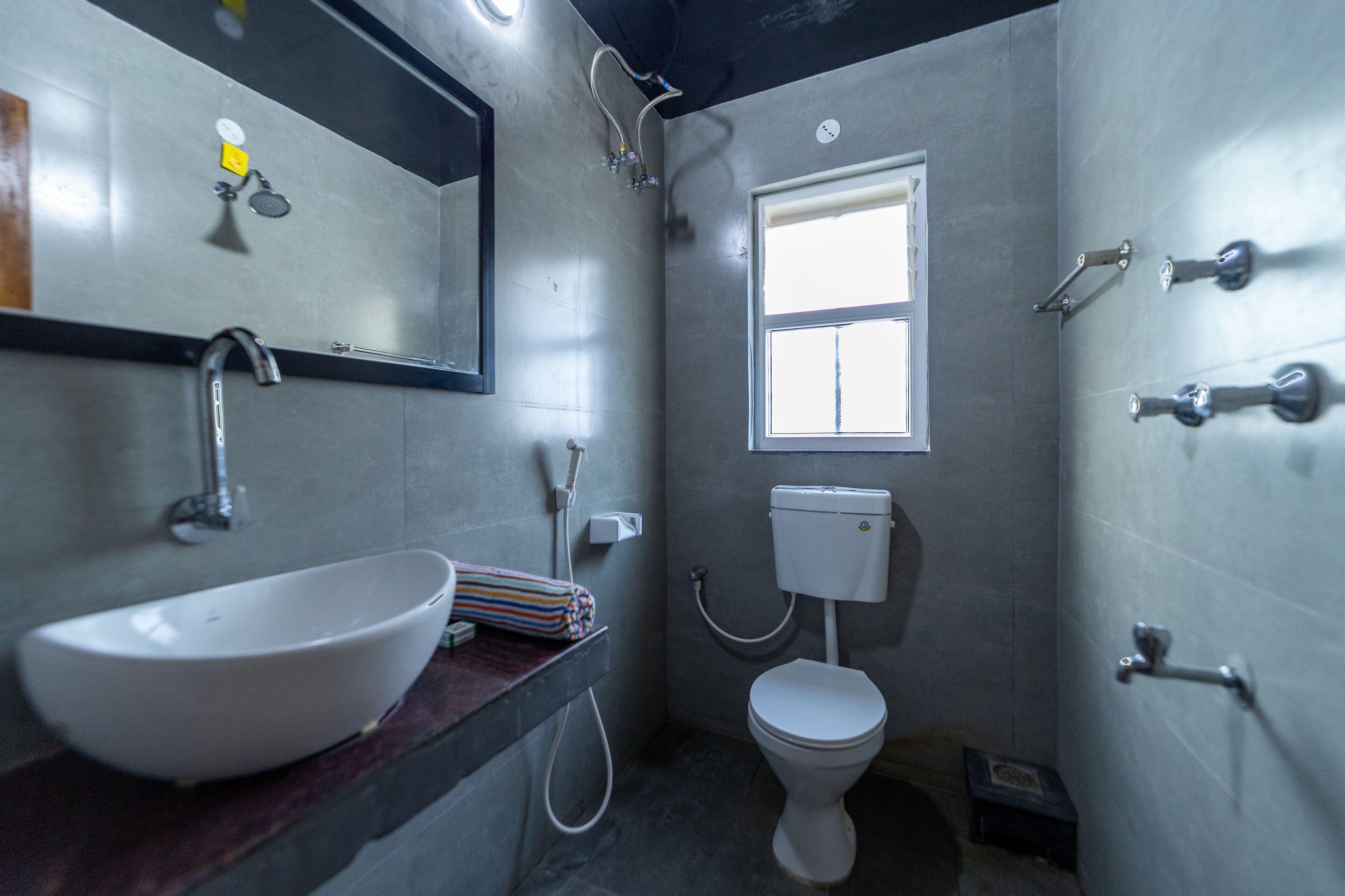 A bathroom with a white sink, a toilet, and a shower.