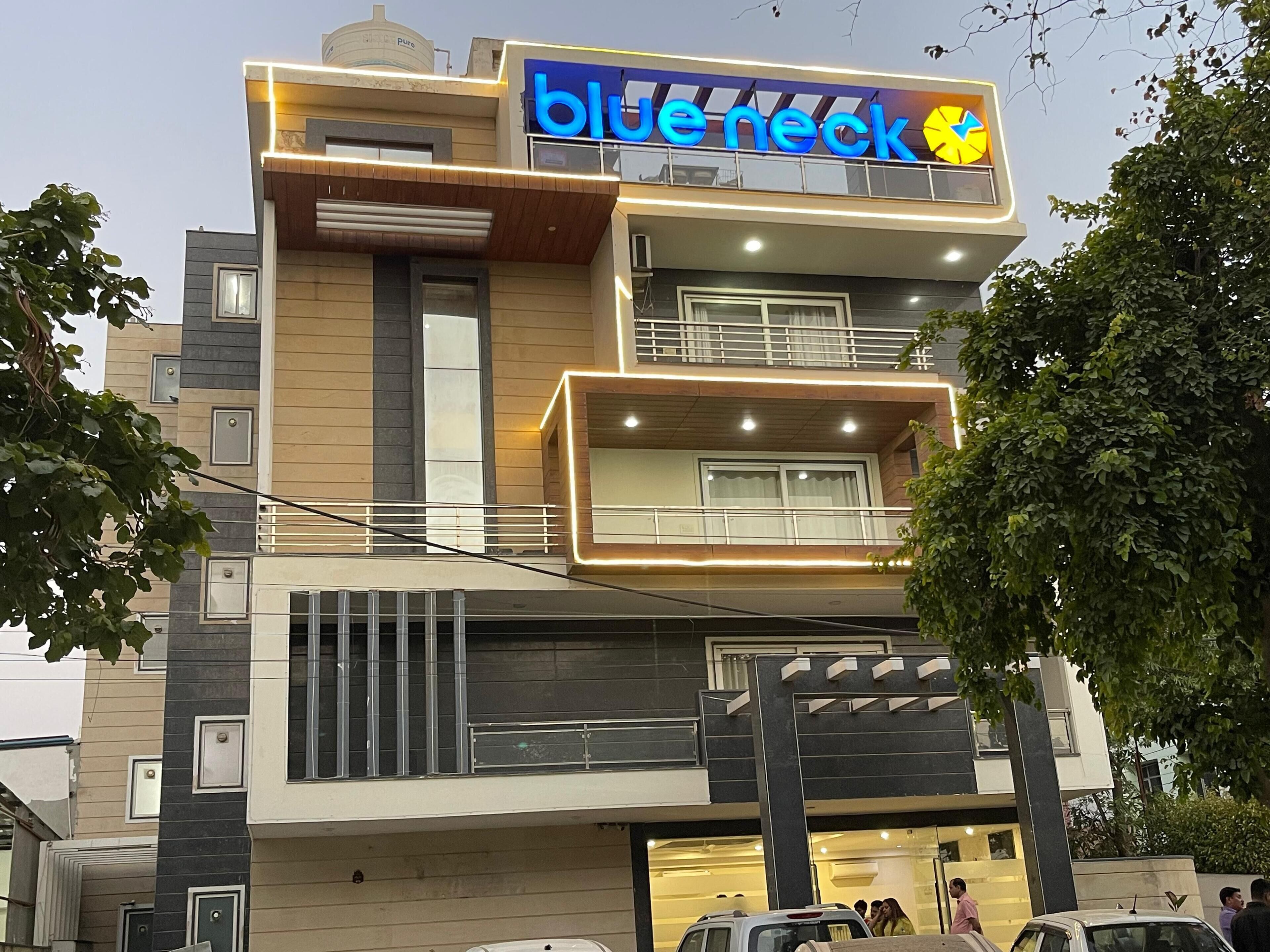 A multi-story building with a prominent 'Blue neck' sign.