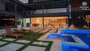A modern hotel with a pool area, outdoor seating, and a bar/lounge area. - OTIA (Maputo)