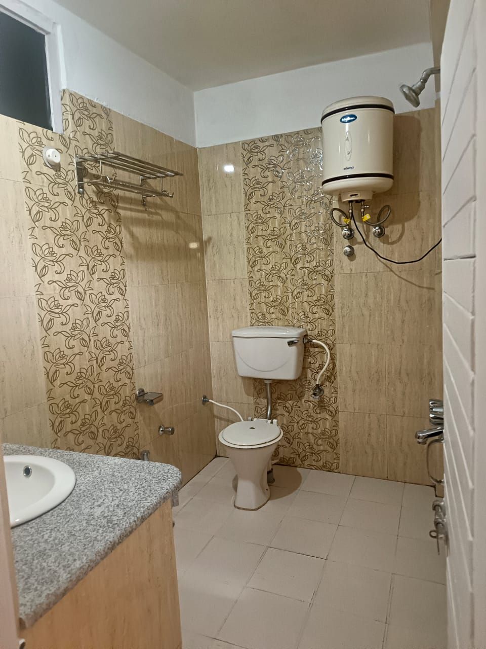 A bathroom with a toilet, a sink, and a shower.