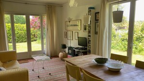 Un salon confortable avec une table à manger, des chaises, un canapé et un téléviseur.