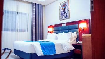 Habitación Deluxe | Ropa de cama de alta calidad y minibar