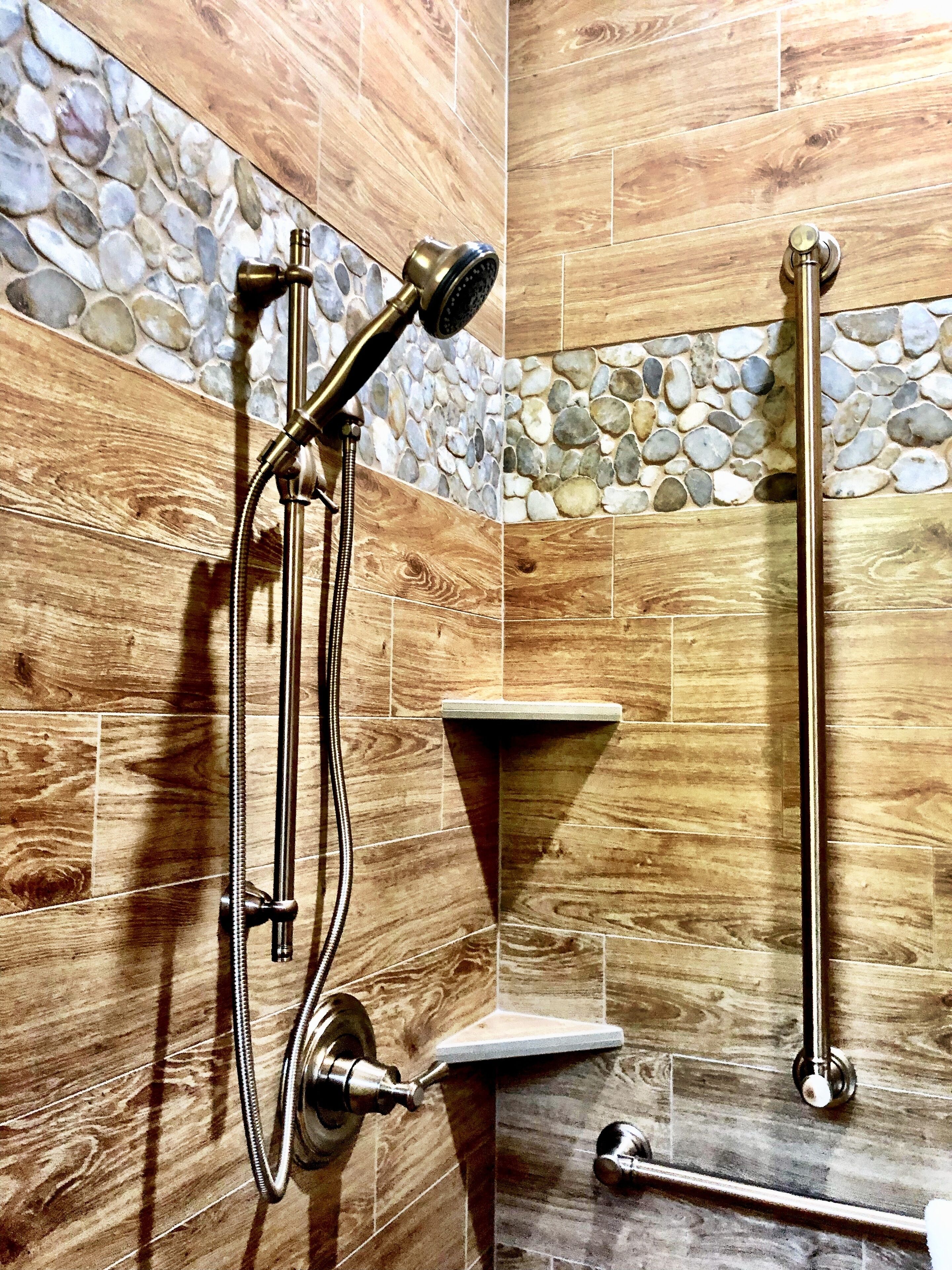 A bathroom with a shower, a toilet, and a sink.