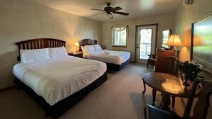 A hotel room with two beds, a ceiling fan, a desk with a chair, and a window. - C8, Two bedroom, two bath log-sided, lake view luxury cottage with hot tub by RedAwning (Mount Ida)