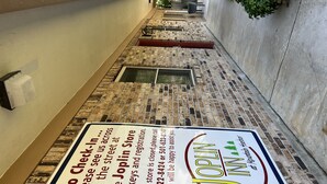 A sign on a brick wall advertising the Joplin Inn.