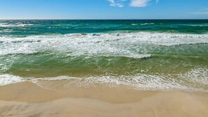 A beach with clear blue water and a sandy shore. - The Summit 307 - Gulf Front Condo with Beach Views (Panama City)