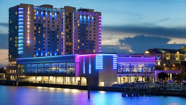 A hotel with a modern design, featuring a prominent 'LAND VIEW' sign, a waterfront location, and a well-lit facade. - Magnolia Beach House l Brand NEW AC UNIT (Gulfport)