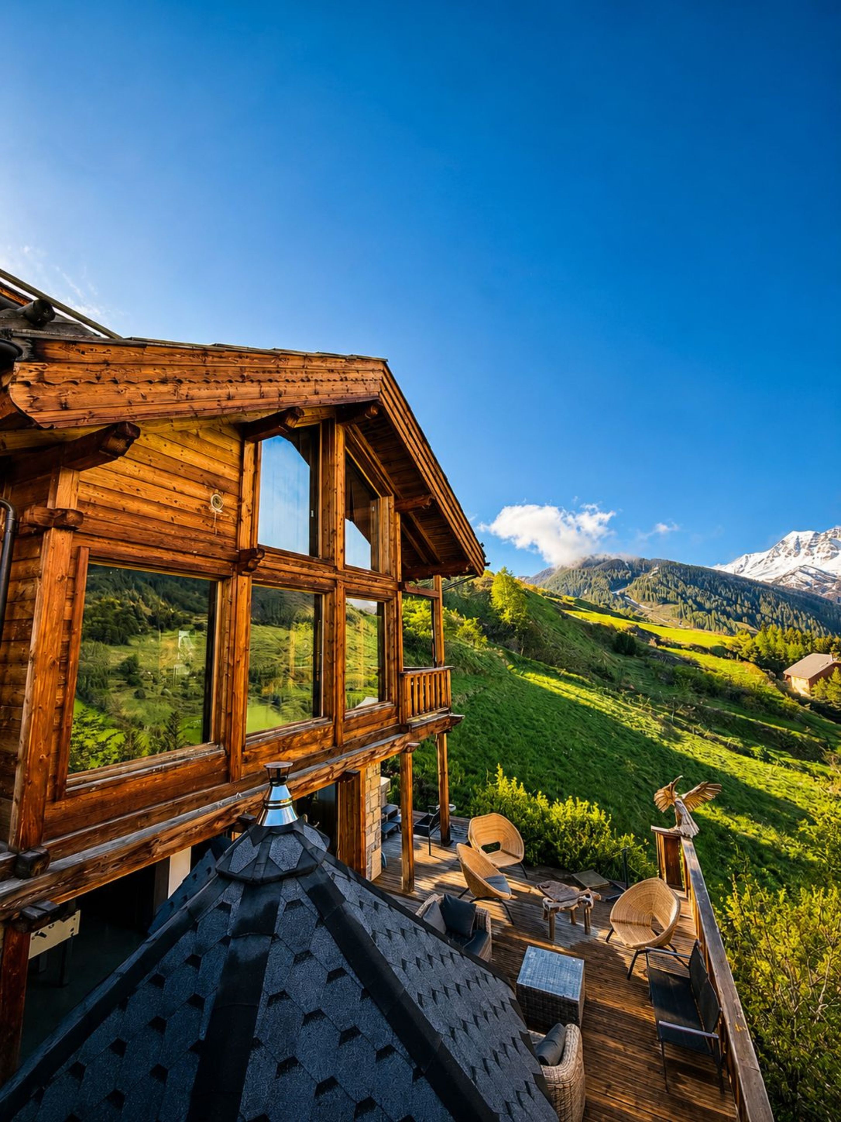 A wooden cabin with a balcony overlooking a mountainous landscape.