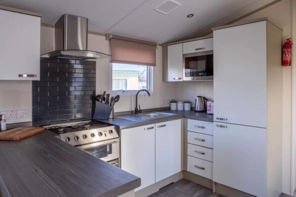Enjoy cooking in this well-equipped kitchen with a gas stove, oven, and microwave.