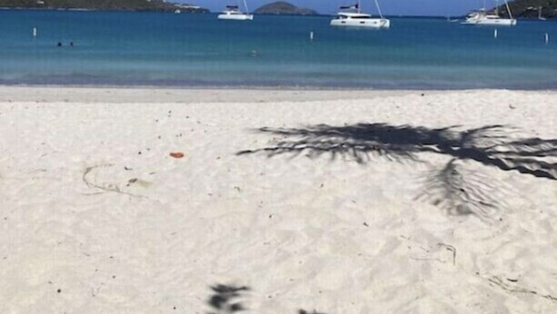 A beach with white sand and clear blue water. There are several sailboats anchored in the distance. - Updated 1BR/1BA - "Hillside Getaway" (Lovenlund)