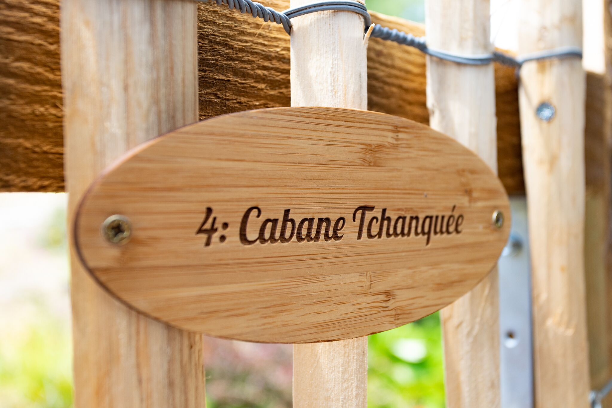 A wooden sign with the text '4: Cabane Tchanguee' indicating a specific location or room number.