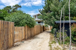 Set amidst lush surroundings, this two-story house offers a balcony and a charming entrance.